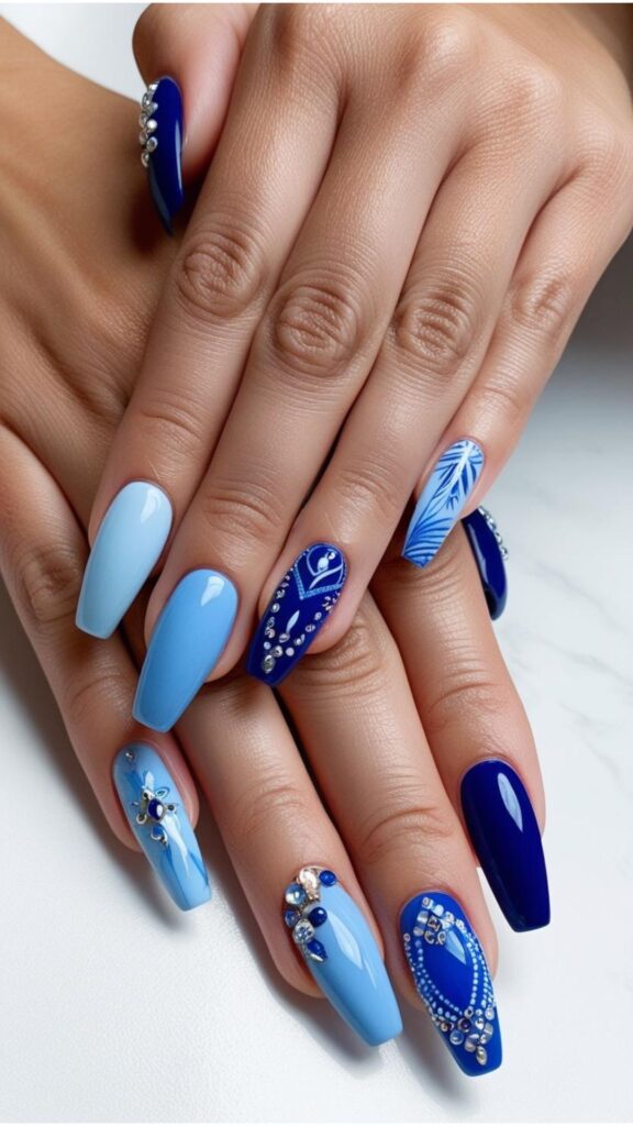 Hands with blue nail designs, showcasing various shades of blue and design variations