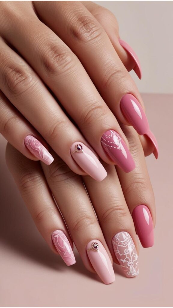 Hands with pink nails, showcasing various shades of pink and nail art designs.