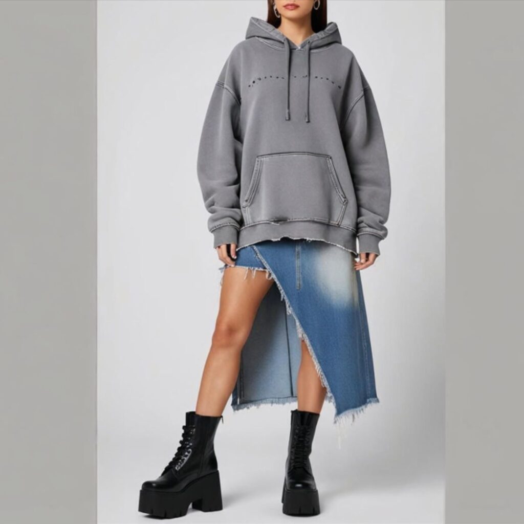 A hoodie with a distressed long denim skirt and platform boots creates a cool, edgy look. The hoodie adds comfort, while the skirt and boots add a bold, streetwear-inspired vibe.